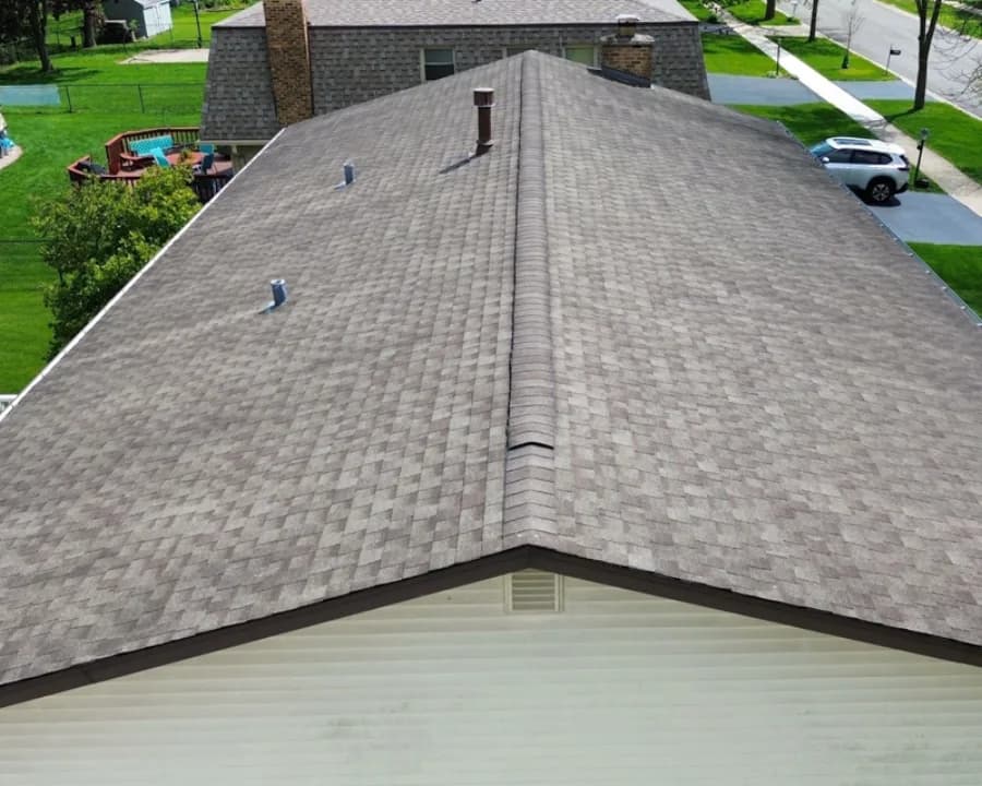 Local home with worn shingles before replacement
