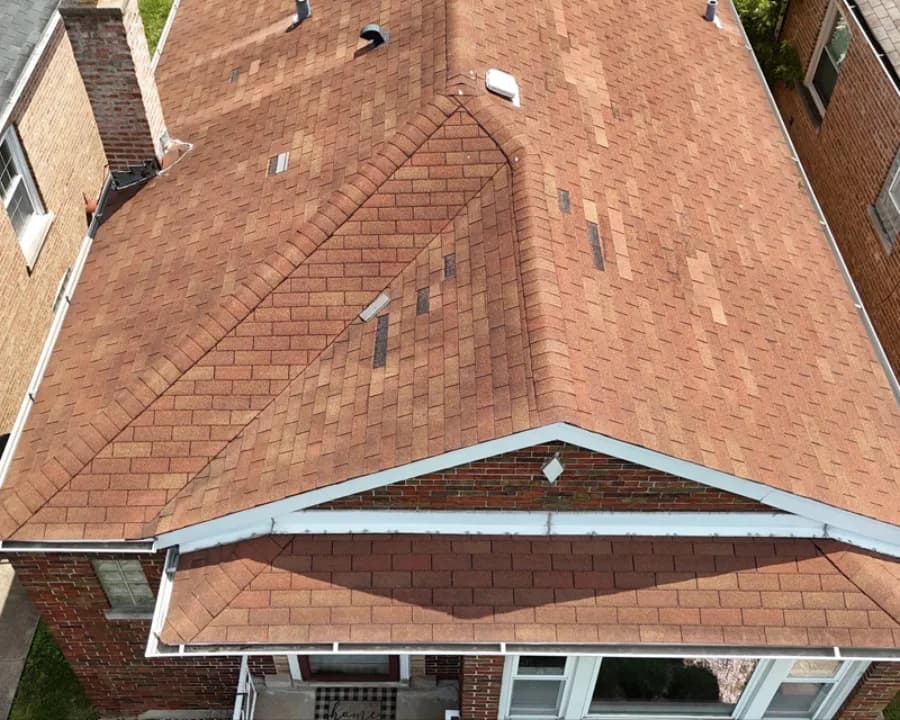 Local home with repeatedly patched shingles before replacement