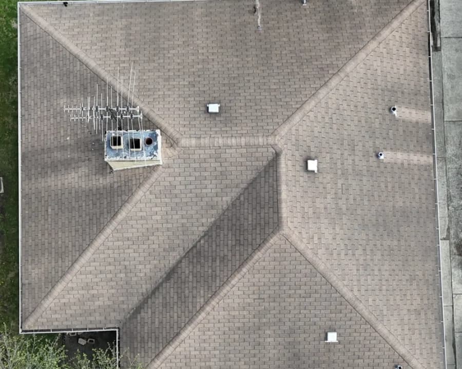 Local home with sun-faded shingles before replacement
