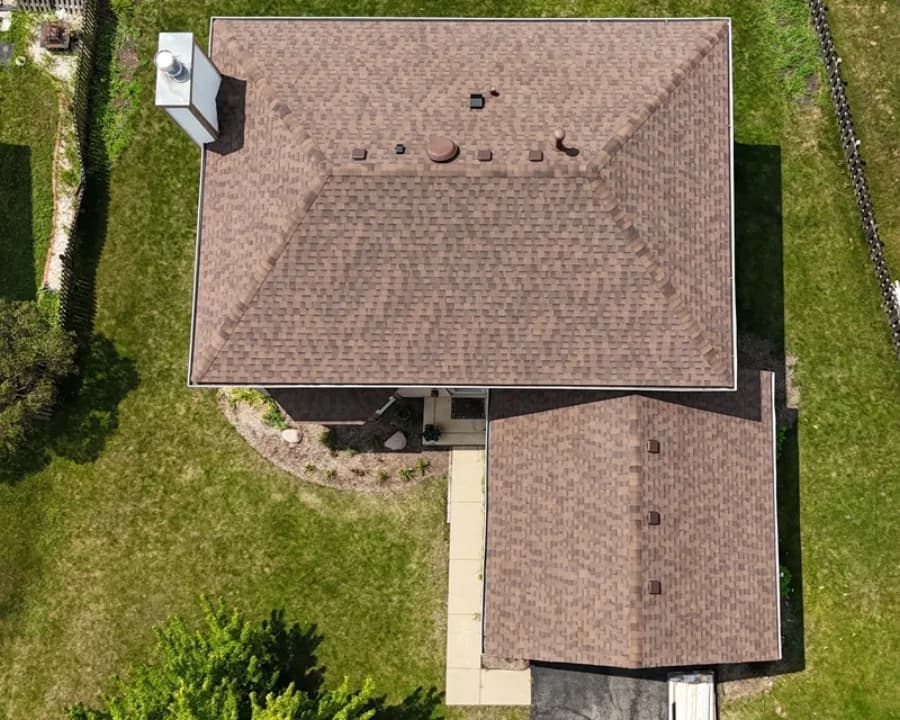 Local home with weathered shingles after replacement