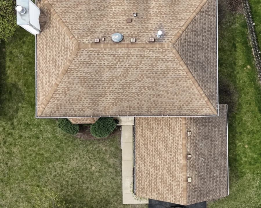 Local home with weathered shingles before replacement
